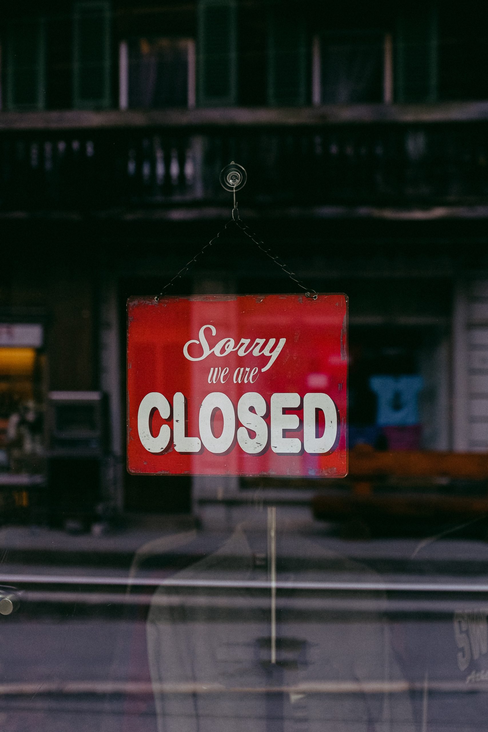 Closed Business Sign in a Shop Window