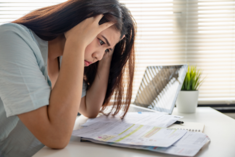 Woman stressing over insurance paperwork